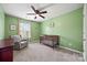 This Bedroom features green walls, a ceiling fan, window, rocking chair, and a crib at 449 Misty Law Ln, Clover, SC 29710
