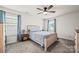 Comfortable bedroom with a ceiling fan, carpeted floor, and natural light from two windows at 449 Misty Law Ln, Clover, SC 29710