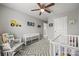 Charming Bedroom with grey walls, ceiling fan, carpeted floors, and construction-themed decor at 449 Misty Law Ln, Clover, SC 29710