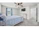 Bright bedroom features a ceiling fan, TV, and a window with blue curtains at 449 Misty Law Ln, Clover, SC 29710