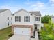 Attractive two-story home with brick and siding, enhanced by dark shutters and a landscaped front yard at 449 Misty Law Ln, Clover, SC 29710