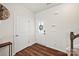 Bright foyer with hardwood floors, white door with glass and decorative wreath at 449 Misty Law Ln, Clover, SC 29710