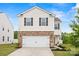 Charming two-story home with white siding, brick accents, dark shutters, and a two-car garage at 449 Misty Law Ln, Clover, SC 29710