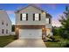 Two-story home with white siding, brick accents, dark shutters, and a two-car garage at 449 Misty Law Ln, Clover, SC 29710