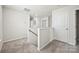 Second-floor hallway with neutral carpet and white doors, leading to bedrooms and bathrooms at 449 Misty Law Ln, Clover, SC 29710