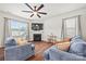 Cozy living room with a fireplace, large windows, and comfortable sofas at 449 Misty Law Ln, Clover, SC 29710