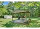 Backyard featuring a covered outdoor grilling area with a table, grill, and seating at 4648 Rifle Range Rd, Conover, NC 28613