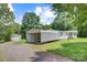 Charming single-story home with a carport and detached garage surrounded by mature trees on a sunny day at 4648 Rifle Range Rd, Conover, NC 28613