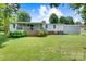 Home back yard featuring a long porch, mature trees and lush green lawn at 4648 Rifle Range Rd, Conover, NC 28613