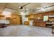 Unfinished garage space with rustic wood walls, storage shelves, and functional utility sink at 4648 Rifle Range Rd, Conover, NC 28613