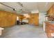 Large, unfinished garage with ample storage space, shelving and a utility sink at 4648 Rifle Range Rd, Conover, NC 28613