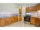 Kitchen featuring wooden cabinets, stainless steel appliances, mosaic tile backsplash and tile flooring at 4648 Rifle Range Rd, Conover, NC 28613