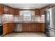 Kitchen featuring wooden cabinets, stainless steel appliances, mosaic backsplash and tile floors at 4648 Rifle Range Rd, Conover, NC 28613