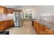 Kitchen with wooden cabinets, stainless steel appliances, mosaic backsplash and tile floors at 4648 Rifle Range Rd, Conover, NC 28613