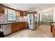 Kitchen with wooden cabinets, stainless steel appliances, mosaic tile backsplash and tile floors at 4648 Rifle Range Rd, Conover, NC 28613