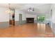 Open living room with a stone fireplace, light-colored hardwood floors and a sliding door to the rear deck at 4648 Rifle Range Rd, Conover, NC 28613