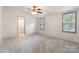 Bright main bedroom with neutral carpet, ceiling fan, and bathroom access for a relaxing retreat at 4648 Rifle Range Rd, Conover, NC 28613