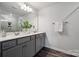 Bathroom features double vanity, granite countertop, large mirror and walk-in shower at 4750 Lakeview N Rd # 18, Charlotte, NC 28216
