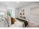 Comfortable bedroom featuring carpeted floors, a tufted headboard, and neutral decor at 4750 Lakeview N Rd # 18, Charlotte, NC 28216