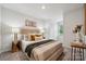 Cozy bedroom featuring carpeted floors, a tufted headboard, and neutral decor at 4750 Lakeview N Rd # 18, Charlotte, NC 28216