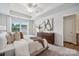 Bright main bedroom boasts trey ceiling, neutral colors, and large windows at 4750 Lakeview N Rd # 18, Charlotte, NC 28216
