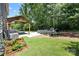 Lush backyard with a covered pavilion, inviting fire pit and outdoor seating for relaxing and entertaining at 5088 Watersail Way, Clover, SC 29710