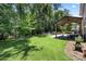 Large, well-maintained lawn with covered patio and an outdoor fire pit, perfect for entertaining and relaxation at 5088 Watersail Way, Clover, SC 29710