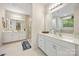Bright bathroom featuring double sink vanity, walk-in shower, and neutral tile floors at 5088 Watersail Way, Clover, SC 29710