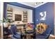 Comfortable dining area with a glass table, blue chairs, and built-in shelves, perfect for entertaining guests at 5088 Watersail Way, Clover, SC 29710