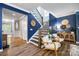 Inviting entryway with staircase, accent wall, and sitting area with stylish decor at 5088 Watersail Way, Clover, SC 29710