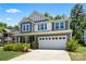 Beautiful two-story home featuring a gray exterior, a two-car garage, and a well-manicured front lawn at 5088 Watersail Way, Clover, SC 29710