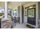 Inviting front porch with stone accents, comfortable seating, and a welcoming entrance at 5088 Watersail Way, Clover, SC 29710