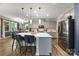 Beautiful kitchen featuring a large island with bar seating, stainless steel appliances, and hardwood flooring at 5088 Watersail Way, Clover, SC 29710
