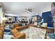 Spacious open-concept living room with hardwood floors, comfortable seating, stylish furnishings, and seamless flow to the kitchen area at 5088 Watersail Way, Clover, SC 29710
