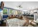 Spacious living room featuring hardwood floors, large windows, and comfortable seating with an open kitchen at 5088 Watersail Way, Clover, SC 29710