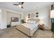 Well-lit primary bedroom featuring plush carpeting, ceiling fan and a TV on top of a white dresser at 5088 Watersail Way, Clover, SC 29710