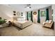 Spacious bedroom featuring a tufted bed, a ceiling fan, and two large windows with curtains at 5088 Watersail Way, Clover, SC 29710