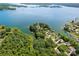 Expansive aerial view of lakefront property featuring waterfront homes surrounded by lush green trees at 5153 Glenwood St, Sherrills Ford, NC 28673