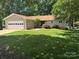 Charming single-story home with well-manicured lawn, mature trees, and attached two-car garage at 5153 Glenwood St, Sherrills Ford, NC 28673
