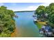 Beautiful lake view featuring covered boat docks, calm water, and lush trees along the shoreline at 5153 Glenwood St, Sherrills Ford, NC 28673