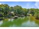 Scenic lake view featuring a boat dock with lifts, lush trees, and a serene waterfront homes at 5153 Glenwood St, Sherrills Ford, NC 28673