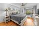Well-lit main bedroom features a ceiling fan, hardwood floors, lake views, and a king-size bed at 5153 Glenwood St, Sherrills Ford, NC 28673