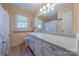 Well-lit bathroom featuring a spacious vanity, mirror, shower and toilet at 5840 Potter Rd, Matthews, NC 28104