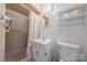 Clean bathroom with a shower, sink and toilet, plus a handy storage shelf at 5840 Potter Rd, Matthews, NC 28104