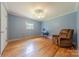 Comfortable bedroom with hardwood floors and a recliner, offering a relaxing retreat at 5840 Potter Rd, Matthews, NC 28104