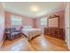 Charming bedroom with a queen bed, hardwood floors, dresser, and ample natural light at 5840 Potter Rd, Matthews, NC 28104