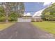 Charming brick home with an attached two-car garage and a spacious driveway on a well-manicured lawn at 5840 Potter Rd, Matthews, NC 28104