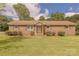 Charming brick home with a well-manicured lawn and mature landscaping at 5840 Potter Rd, Matthews, NC 28104