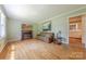 Bright living room with hardwood floors, a fireplace, and a comfortable sofa at 5840 Potter Rd, Matthews, NC 28104