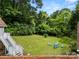 Backyard featuring a fire pit with Adirondack chairs and lush landscaping at 607 Coulwood Dr, Charlotte, NC 28214
